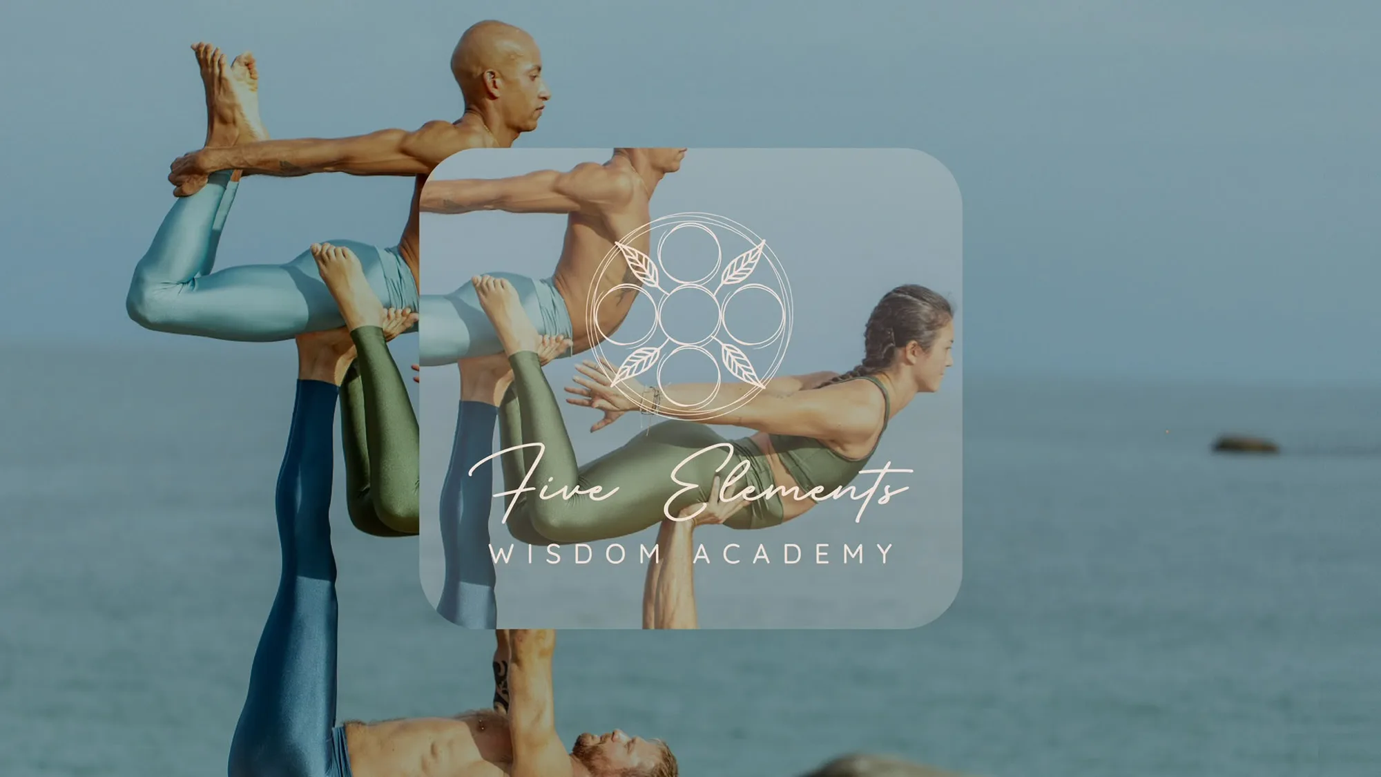 Acro yoga on the rocks by the sea, with the Five Elements Wisdom Academy mark
