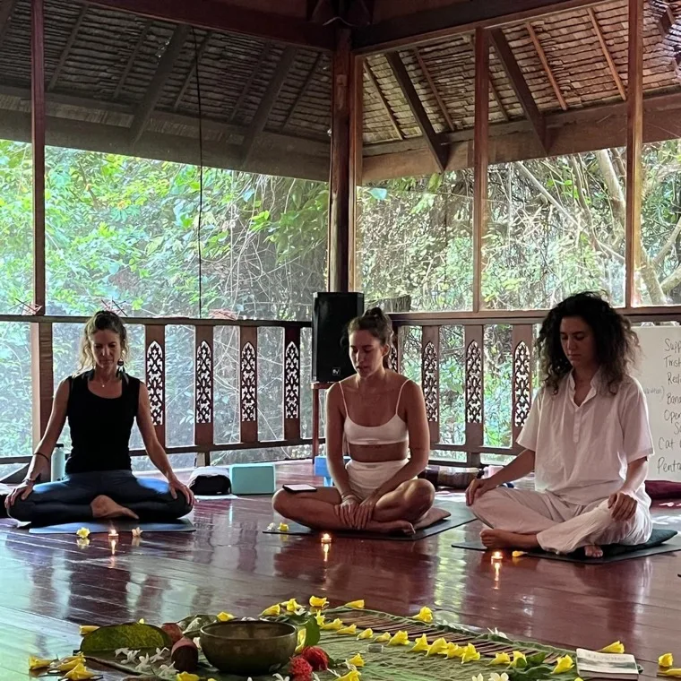 An opening ceremony with flowers, candles and singing bowls in the shala