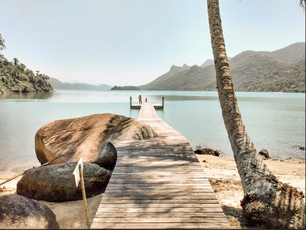 A wooden pier reaching into the calm bay